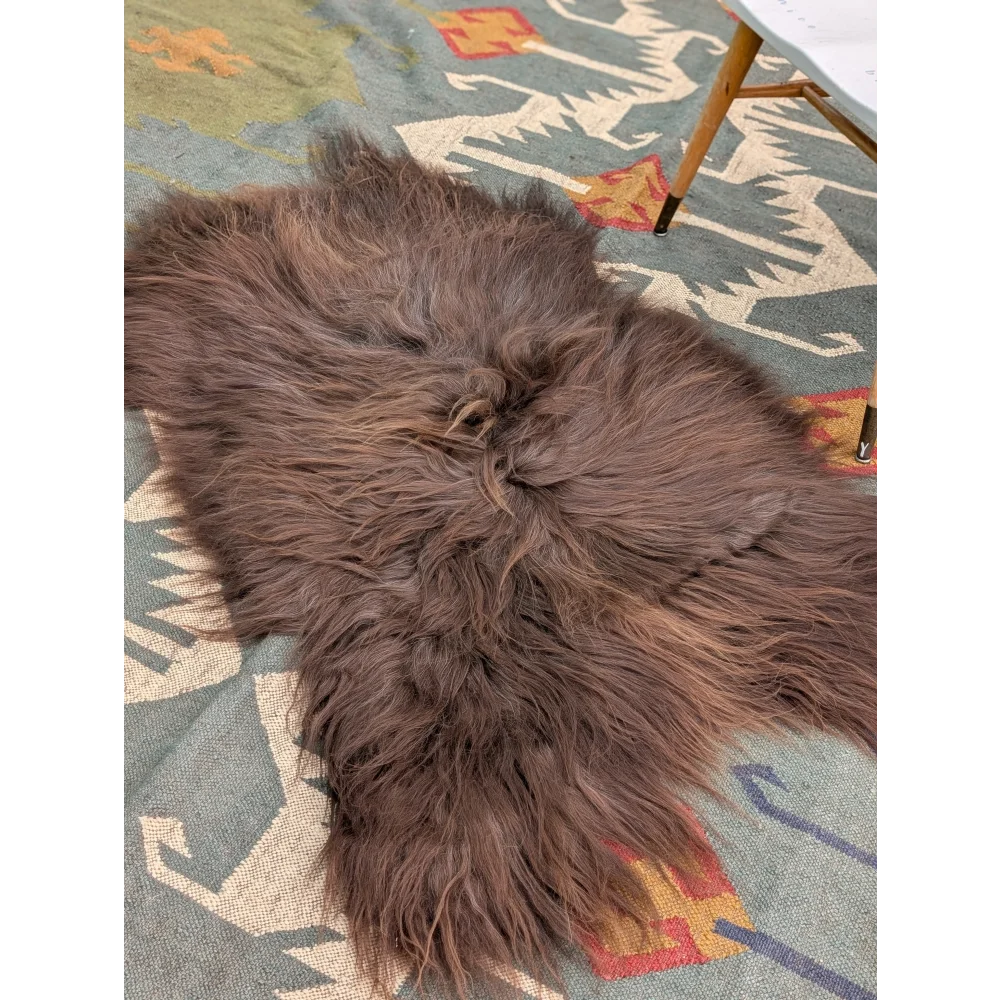 A massive 58 by 35 inch thick brown icelandic sheepskin rug with long wool icelandic texture by angus oliver