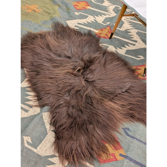 A massive 58 by 35 inch thick brown icelandic sheepskin rug with long wool icelandic texture by angus oliver