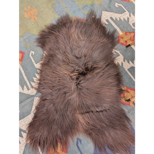 A plush 58 by 35 inch gray icelandic sheepskin rug with long wool and natural shade variations by angus oliver
