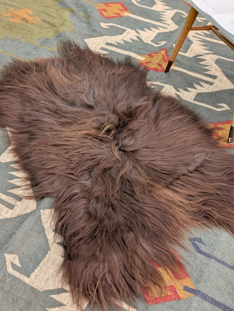 A massive 58 by 35 inch thick brown icelandic sheepskin rug with long wool icelandic texture by angus oliver