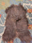 A plush 58 by 35 inch gray icelandic sheepskin rug with long wool and natural shade variations by angus oliver