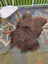A plush brown long wool icelandic sheepskin rug by angus oliver lying on a patterned carpet measuring 58 by 35 inches
