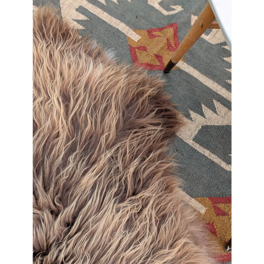 A plush long wool icelandic sheepskin rug in brown and beige with soft natural texture by angus oliver