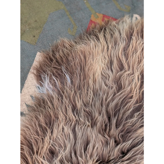 A plush long wool icelandic sheepskin rug in beige and brown tones by angus oliver measuring 59 x 34 inches