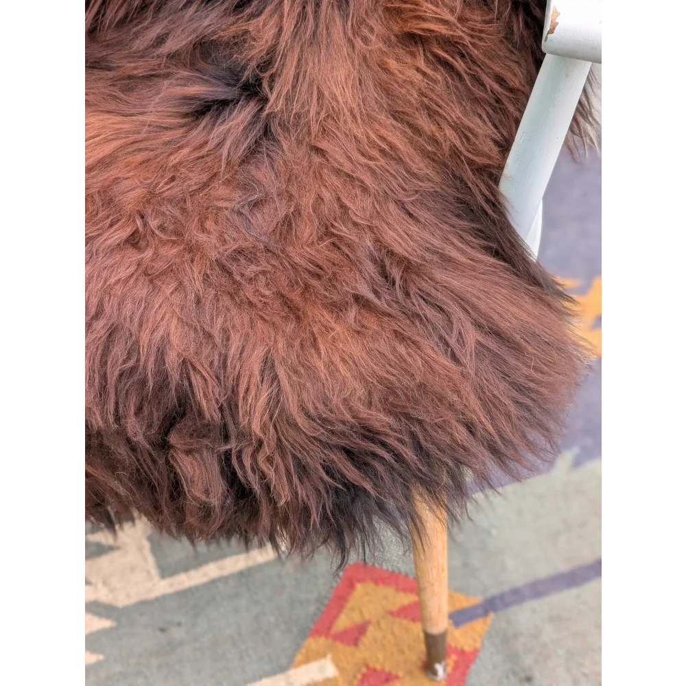 A plush deep brown extra large icelandic sheepskin throw with long wool icelandic texture measuring 47 x 32 inches