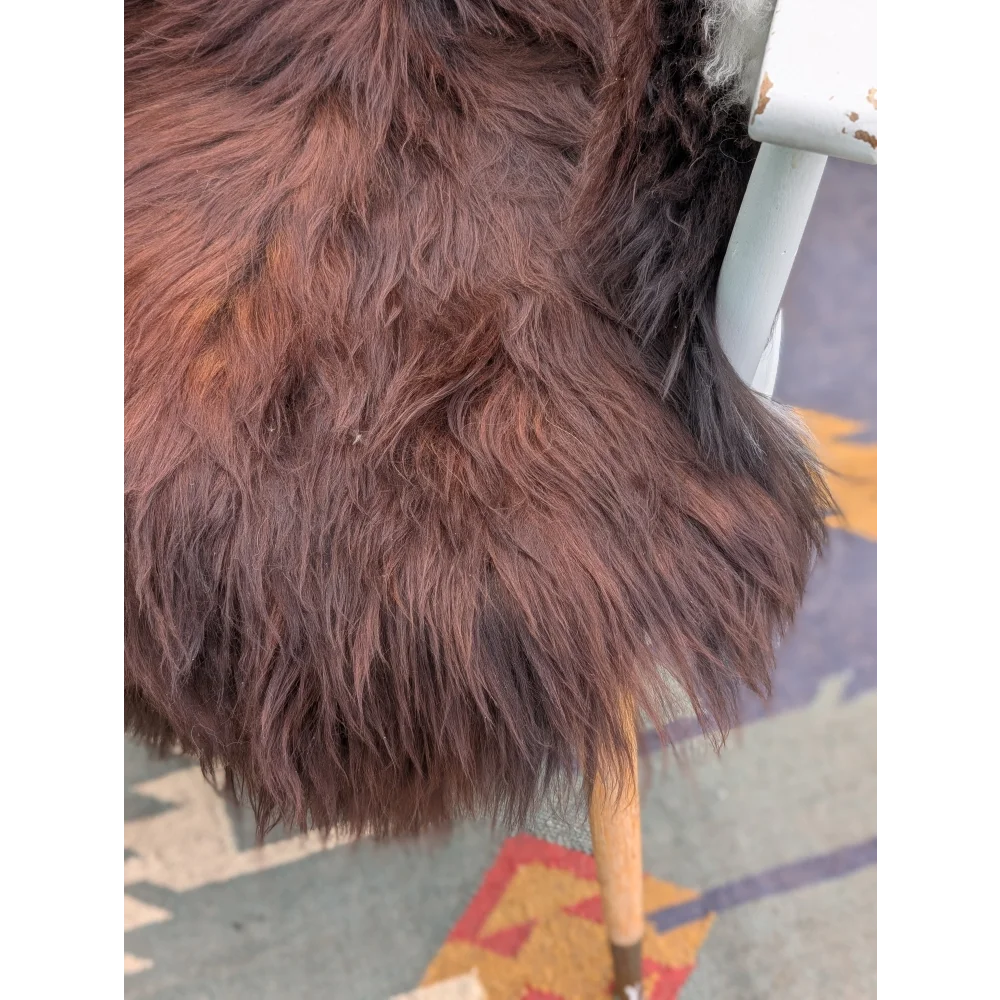 A plush long wool icelandic faux fur coat in brown and black with a soft shaggy texture, extra large icelandic sheepskin