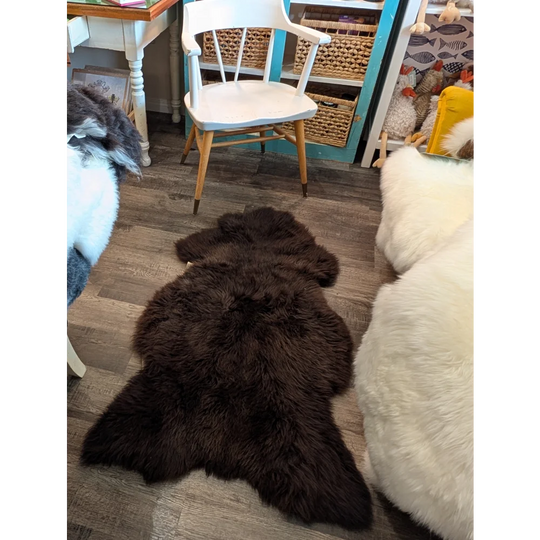 Dark brown fluffy extra large british sheepskin rug with natural fur texture by angus oliver 53 x 30 inches