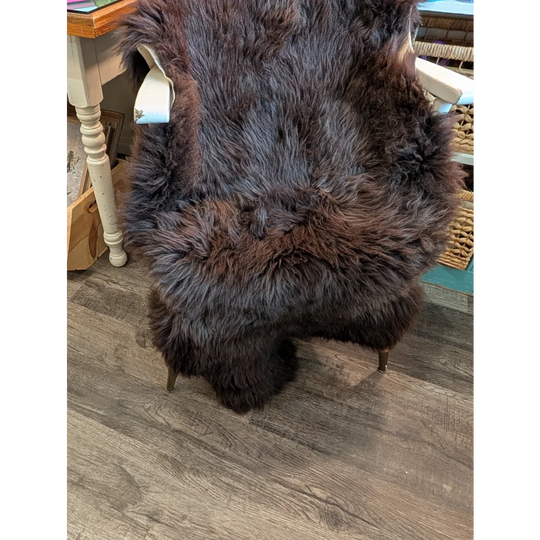 A plush extra large dark brown british sheepskin rug by angus oliver with thick natural fur texture 53 by 30 inches