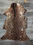 Brown and white tibet highland spotted sheepskin rug with plush curly texture perfect for cozy decor