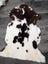 A plush tibet highland spotted grade a- sheepskin rug with natural white and brown spots perfect for cozy decor