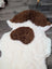 A plush tibet highland spotted grade a- sheepskin rug with white base and brown patches in an abstract pattern