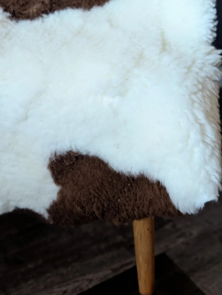 White and brown tibet highland spotted grade a- sheepskin rug with a fluffy natural texture from nat’s grade