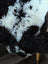 A plush curly black and white tibet highland spotted grade a- sheepskin rug with soft fluffy texture from nat’s grade