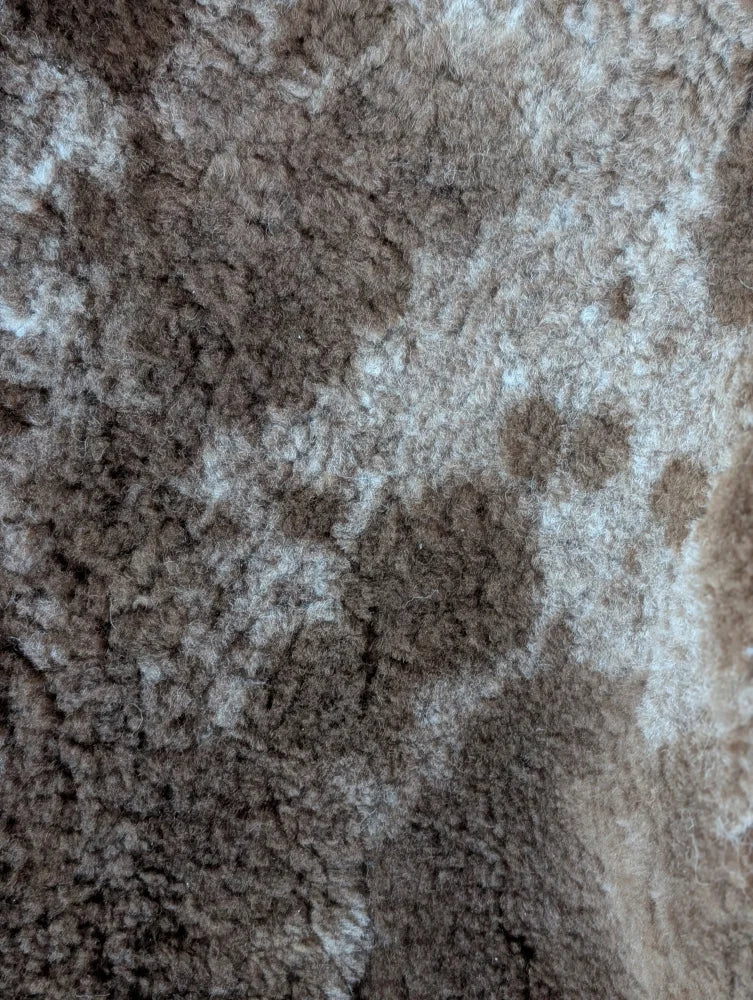 Brown and beige mottled plush tibet highland spotted grade a- sheepskins fabric from nat’s grade collection