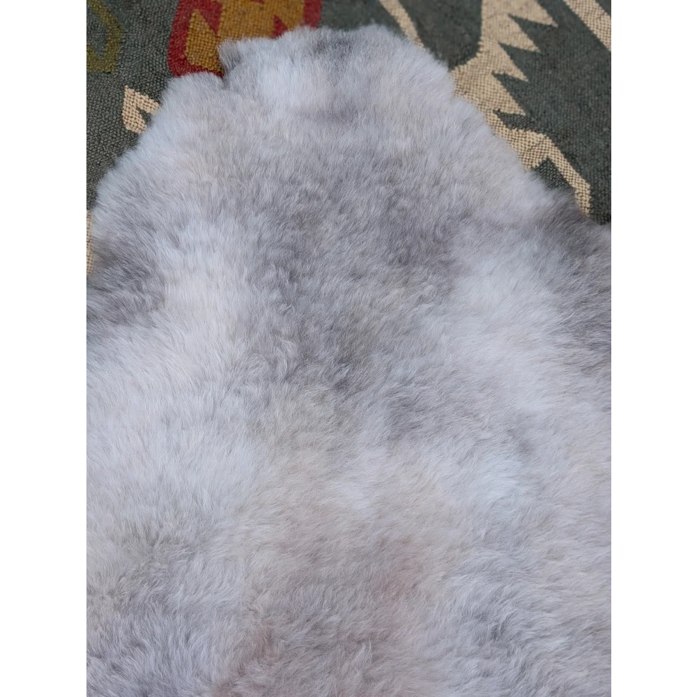 A large 46 x 32 gray sheepskin rug with soft long wool icelandic texture by angus oliver