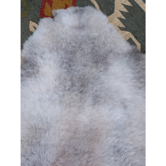 A large 46 x 32 gray sheepskin rug with soft long wool icelandic texture by angus oliver