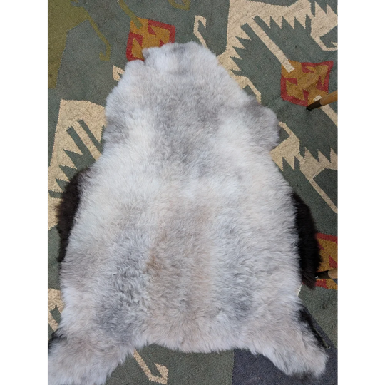 A soft fluffy gray long wool icelandic sheepskin rug with natural mottled texture by angus oliver