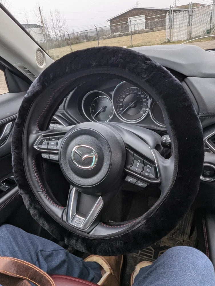 Black sheepskin steering wheel cover with fur trim and Mazda logo by Angus Oliver