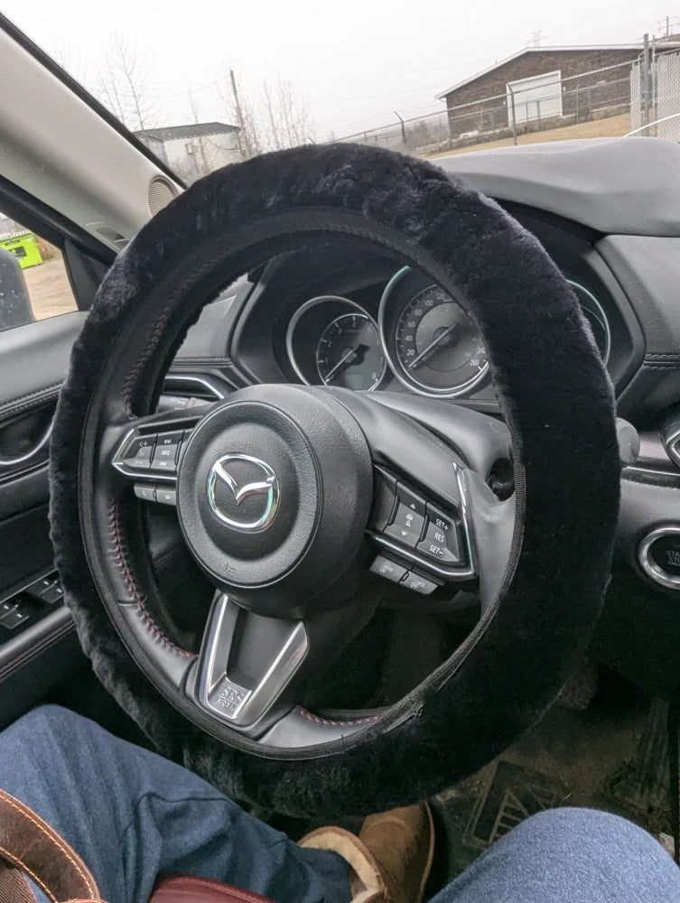 Black fuzzy Angus Oliver steering wheel cover with textured grip
