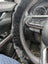 Black sheepskin steering wheel cover with red stitching