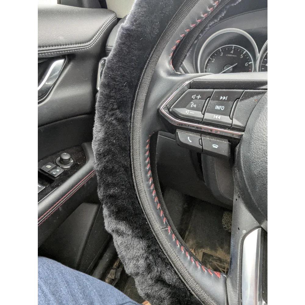 Black sheepskin steering wheel cover with red stitching