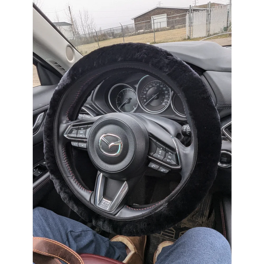 Black sheepskin steering wheel cover with fur trim and Mazda logo by Angus Oliver