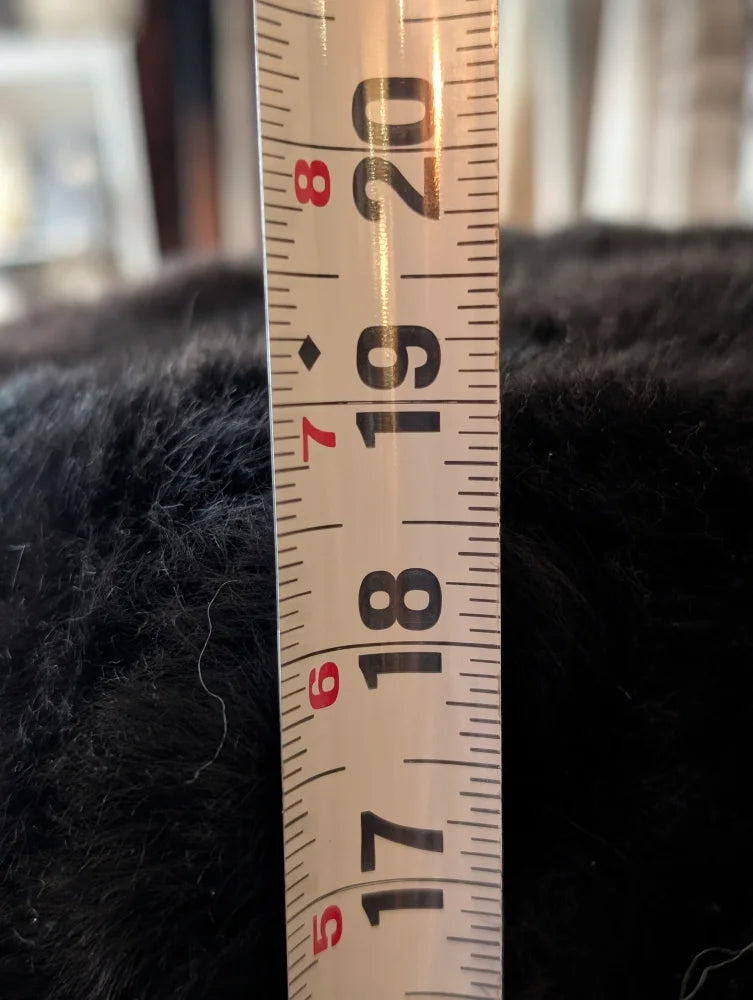 White measuring tape on Angus Oliver Stump Pouf Icelandic sheepskin