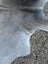 Sun1 80 x 63 lovely cowhide rug showing large cowhide with soft grayish blue color and unique natural texture variations