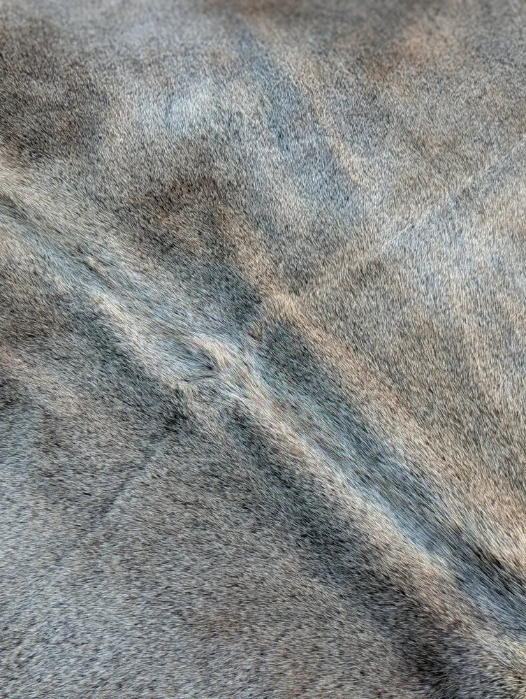 Large cowhide lovely cowhide rug with gray and brown mottled soft textured surface showing unique characteristics