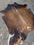 Large lovely cowhide rug in brown and white with natural fur texture showcasing unique characteristics