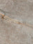 A large cowhide lovely cowhide rug in soft light gray faux fur with beige and tan strands for unique characteristics