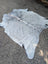 Sun18 large cowhide lovely cowhide rug in white and black speckled with natural fur texture lying flat on pavement