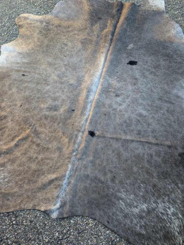 Large cowhide lovely cowhide rug with natural tones and unique characteristics in brown and gray hues