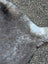 Gray and white speckled soft cowhide rug with unique characteristics perfect as a large lovely cowhide rug