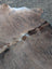 Large lovely cowhide rug with brown and gray natural fur texture showcasing unique characteristics