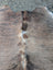 Large lovely cowhide rug in brown and white with natural textured surface showcasing unique characteristics