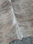 Large lovely cowhide rug with natural brown fur texture and subtle lighter streaks showcasing unique characteristics
