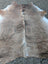 Large natural brown and white cowhide rug with soft textured surface featuring unique characteristics lovely cowhide rug
