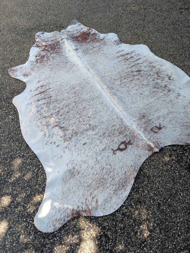 Large cowhide lovely cowhide rug in white and brown with natural markings showcasing unique characteristics