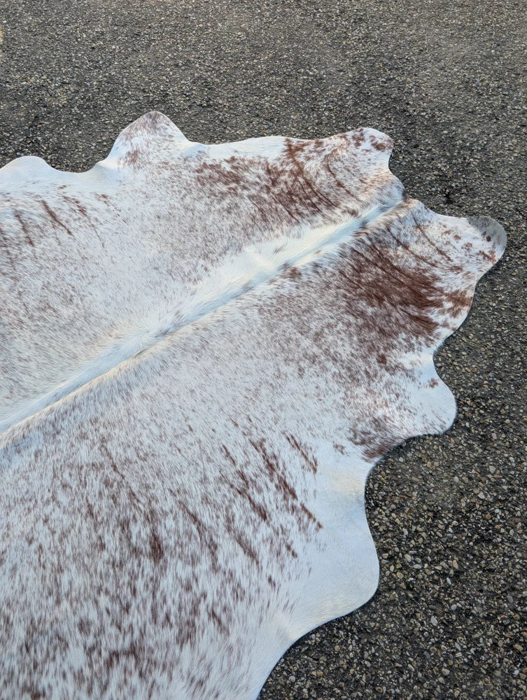 Sun6 84 x 66 lovely cowhide rug features a large cowhide with white and brown spots and unique irregular edges