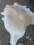 Sun7 large cowhide rug in natural white and light brown with soft textured surface and unique characteristics