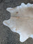 Sun7 86 x 64 large cowhide rug with natural tan and white colors and soft textured surface showcasing unique characteristics