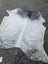 Large black and white cowhide rug with soft textured surface showcasing unique characteristics from sun8 collection