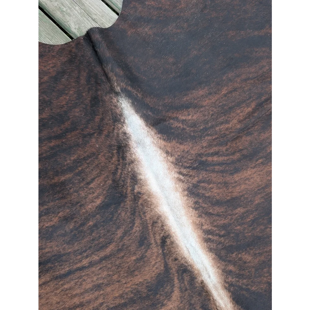 Large cowhide rug with brown and black natural white stripe showcasing unique characteristics in size 66.5 x 63 inches