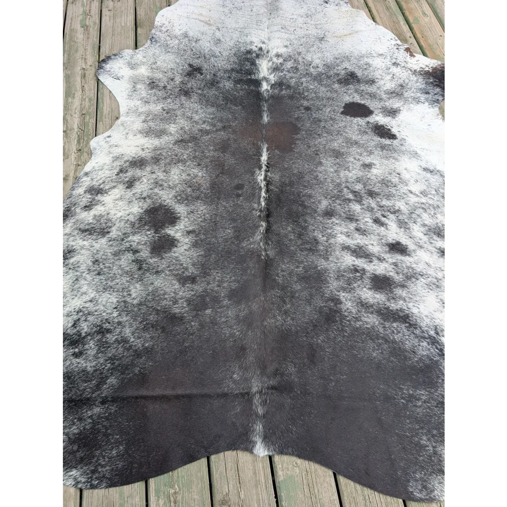Large cowhide rug t10 81 x 61 with black and white natural fur texture showing unique characteristics