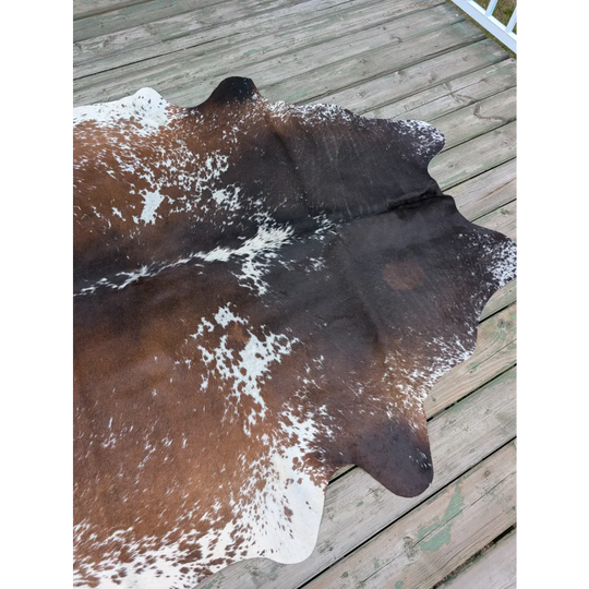 T12 77 x 62 large cowhide rug with brown and white natural irregular patterns showcasing unique characteristics