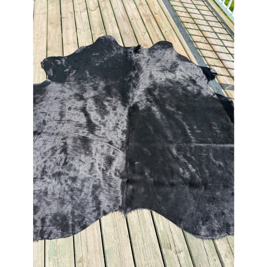 Large cowhide rug t14 with natural textured black fur and subtle gray undertones by angus oliver