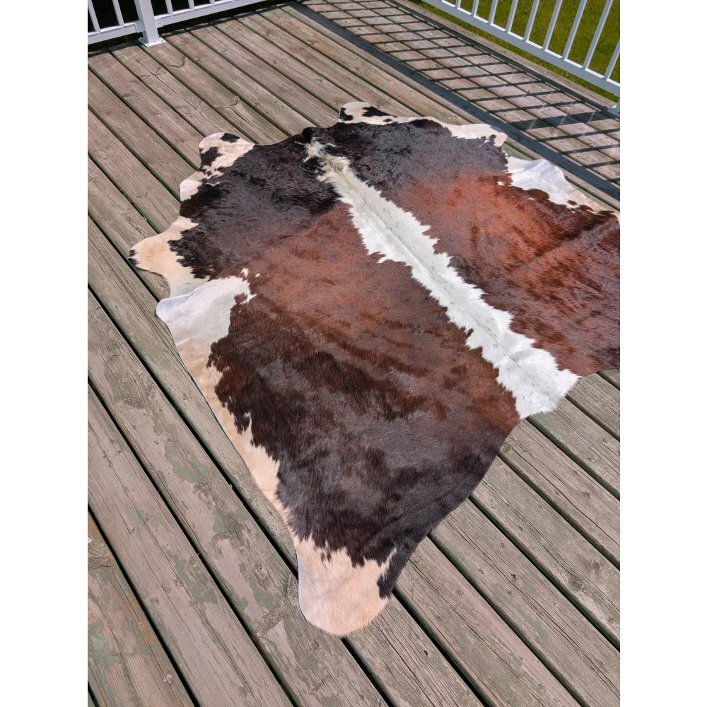 T15 74 x 65 large cowhide rug with a distinctive brown black and white patchwork by angus oliver