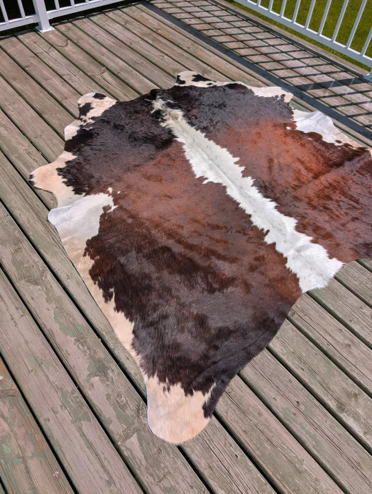 T15 74 x 65 large cowhide rug with a distinctive brown black and white patchwork by angus oliver