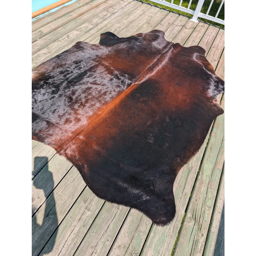 Large cowhide rug angus oliver with a deep black to rich brown and subtle orange gradient perfect for any room